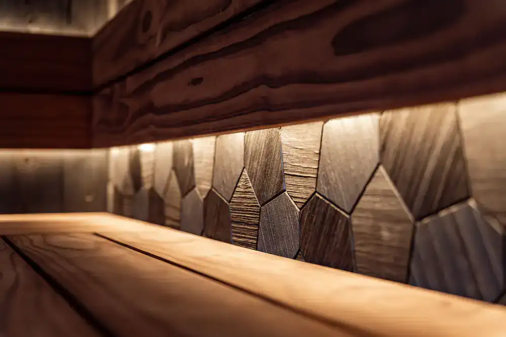 Wide view of a warm timber sauna interior with custom benches