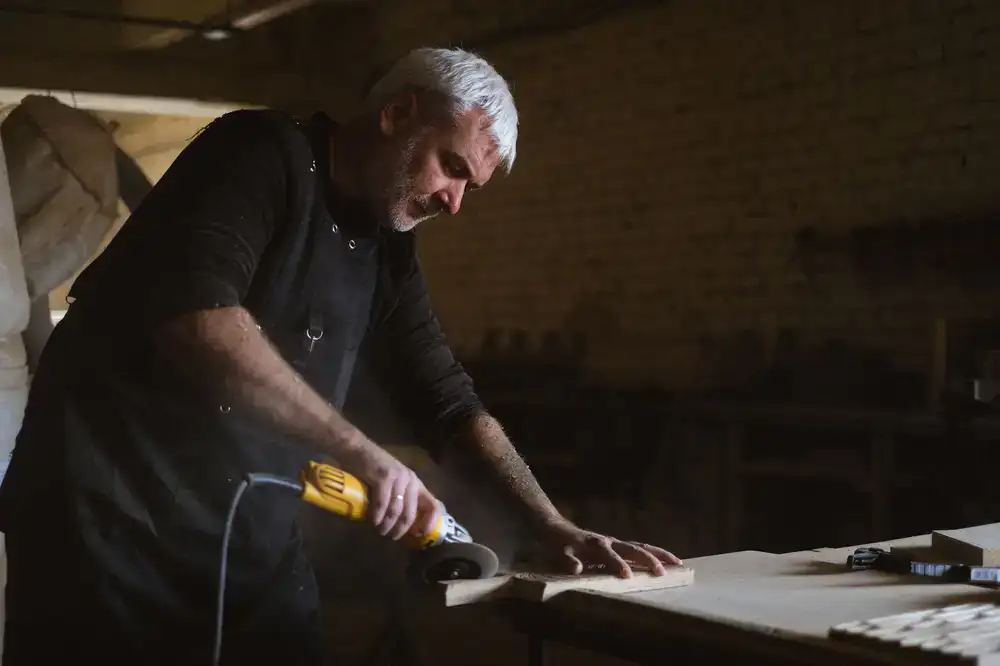 Craftsman shaping honey pine timber in the workshop