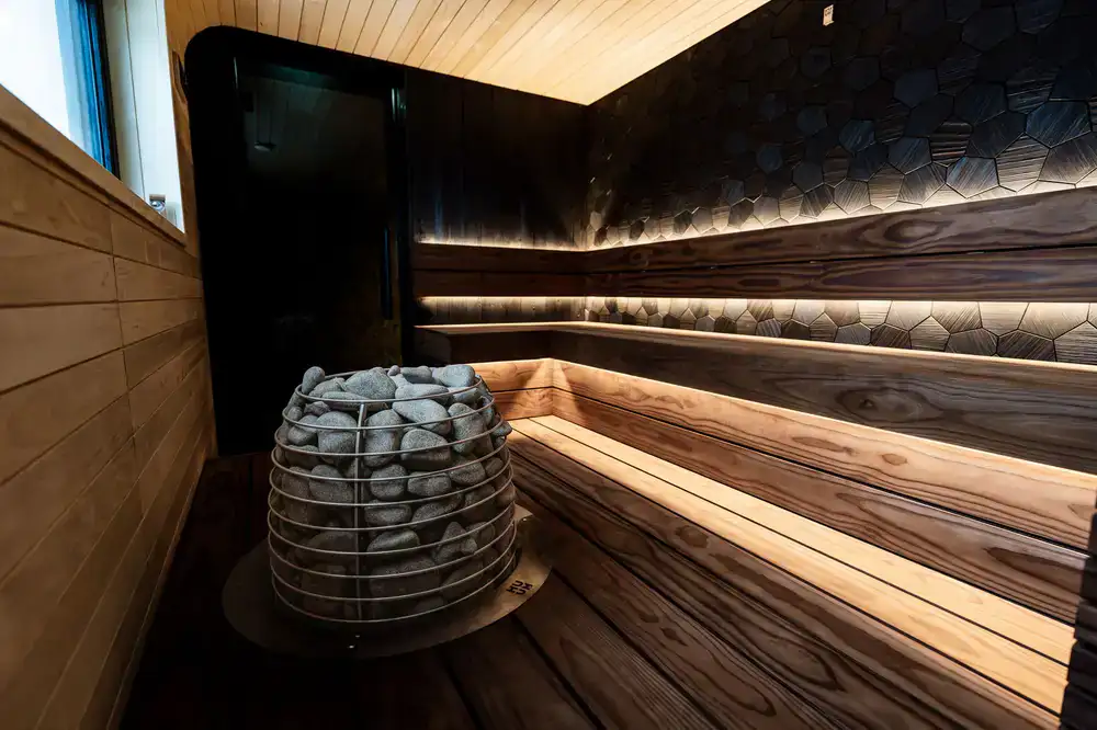 Documentary style photo of an under-stair sauna conversion with frameless glass